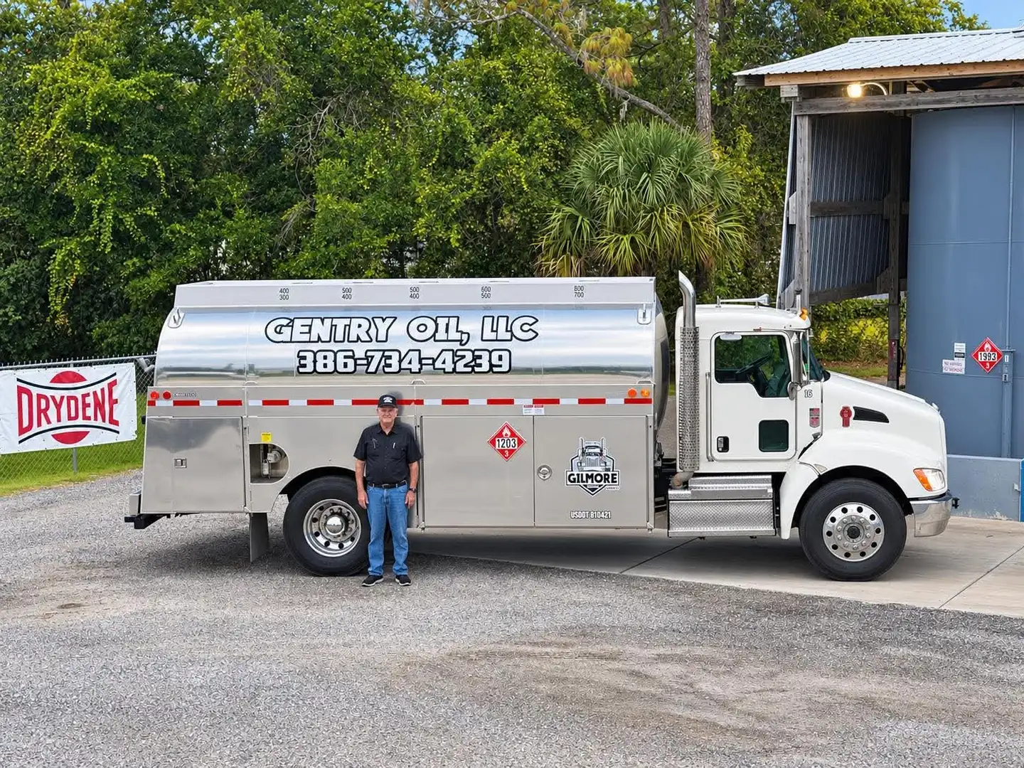 Gentry Oil owner standing next to the Gentry Oil tanker truck, side view